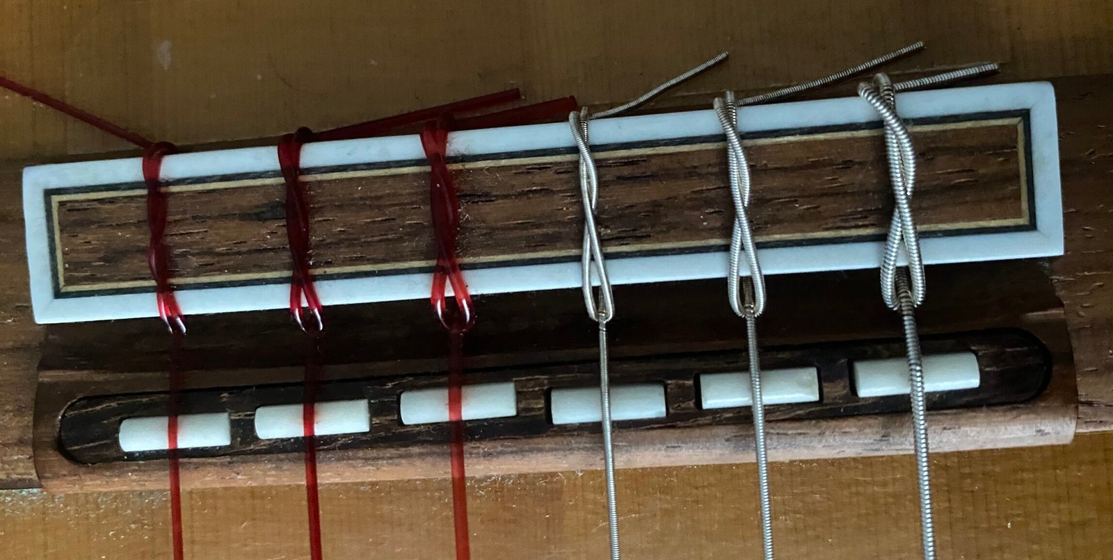 Classical guitar strings tied at the bridge