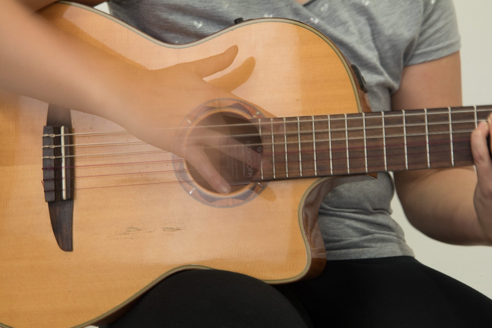 Spanish guitar player demonstrating a strumming technique